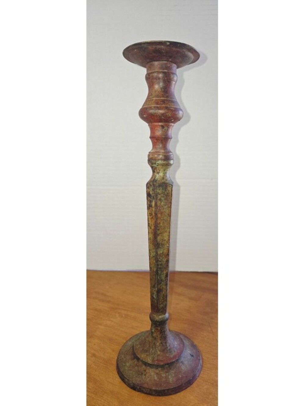 Vintage metal candlestick holder with weathered green and brown patina
